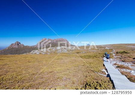 Hikers at Cradle Mountain in Tasmania Australia Hikers at Cradle Mountain in Tasmania Australia 128795950