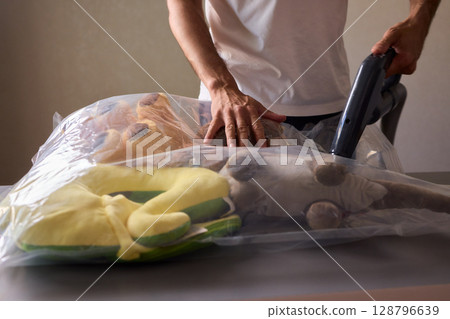 Vacuum Packing Clothing for Effective Space Saving, Efficient Storage, and Better Organization Vacuum Packing Clothing for Effective Space Saving, Efficient Storage, and Better Organization 128796639