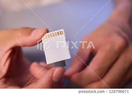Comparison of SD and MicroSD Cards in Different Hands and Their Various Uses and Features 128796671