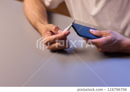 The Innovative Smartphone Cleaning Device is Being Demonstrated During Use and Functionality The Innovative Smartphone Cleaning Device is Being Demonstrated During Use and Functionality 128796706
