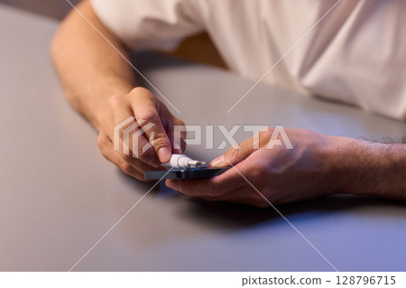 The Innovative Smartphone Cleaning Device is Being Demonstrated During Use and Functionality The Innovative Smartphone Cleaning Device is Being Demonstrated During Use and Functionality 128796715