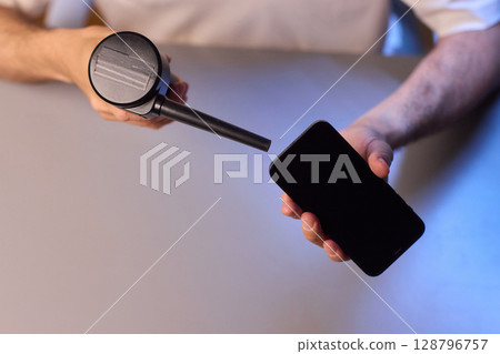 The Innovative Smartphone Cleaning Device is Being Demonstrated During Use and Functionality 128796757