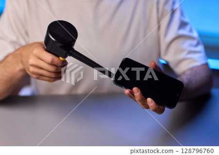 The Innovative Smartphone Cleaning Device is Being Demonstrated During Use and Functionality 128796760