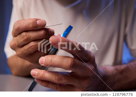 The Innovative Smartphone Cleaning Device is Being Demonstrated During Use and Functionality The Innovative Smartphone Cleaning Device is Being Demonstrated During Use and Functionality 128796778