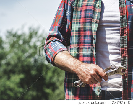 Handsome man and spanners 128797568