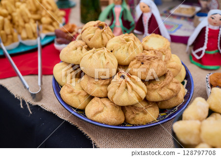 Savor the Delicious Golden Dumplings uchpochmak Beautifully Served on a Colorful and Inviting Table Savor the Delicious Golden Dumplings uchpochmak Beautifully Served on a Colorful and Inviting Table 128797708