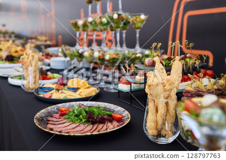 An Elegant Assortment of Gourmet Desserts and Savory Snacks Beautifully Arranged on Table An Elegant Assortment of Gourmet Desserts and Savory Snacks Beautifully Arranged on Table 128797763