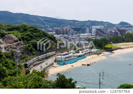 JR Chikuhi Line 305 series train running through the city of Itoshima 128797764