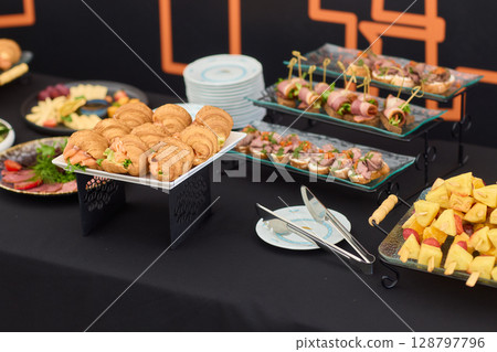 An Elegant Assortment of Gourmet Desserts and Savory Snacks Beautifully Arranged on Table 128797796