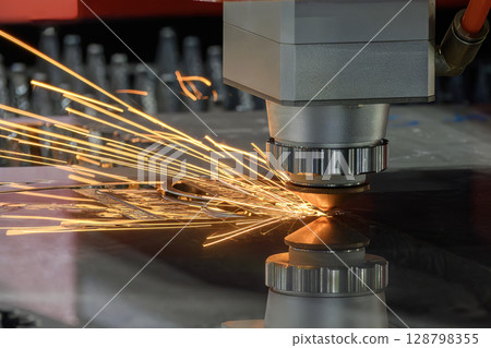 Close up scene the fiber laser cutting machine cut the metal plate control by CNC program. Close up scene the fiber laser cutting machine cut the metal plate control by CNC program. 128798355