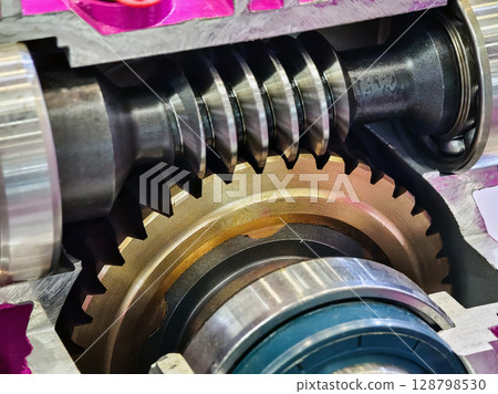 Detailed view of a mechanical gear system showcasing intricate design and engineering principles in industrial machinery Detailed view of a mechanical gear system showcasing intricate design and engineering principles in industrial machinery 128798530