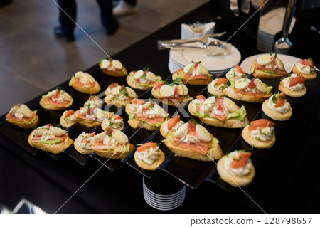 An Elegant Assortment of Gourmet Desserts and Savory Snacks Beautifully Arranged on Table An Elegant Assortment of Gourmet Desserts and Savory Snacks Beautifully Arranged on Table 128798657