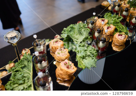 An Elegant Assortment of Gourmet Desserts and Savory Snacks Beautifully Arranged on Table 128798659