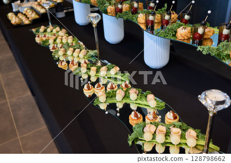 An Elegant Assortment of Gourmet Desserts and Savory Snacks Beautifully Arranged on Table 128798662