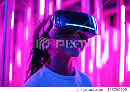 A child wearing VR glasses, smiling while exploring an imaginative virtual reality world 128799609