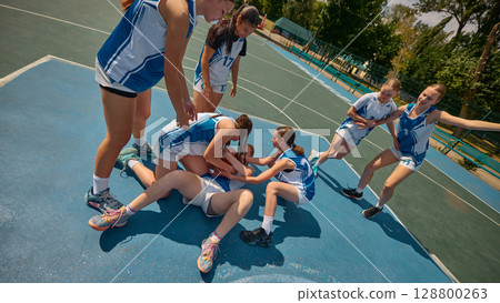 Teenage basketball players emotionally fighting for ball during intense play 128800263