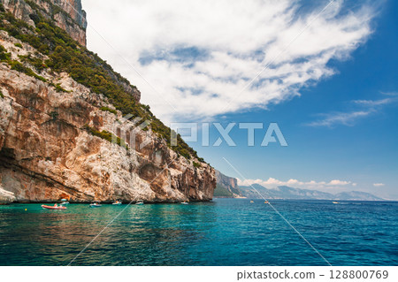Rugged cliffs and anchored vessels at Gulf of Orosei in Sardinia Italy 128800769