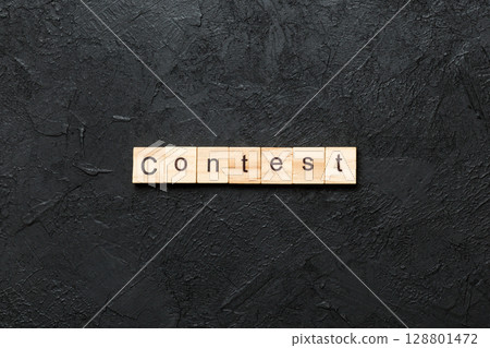 Contest word written on wood block. Contest text on cement table for your desing, Top view concept 128801472