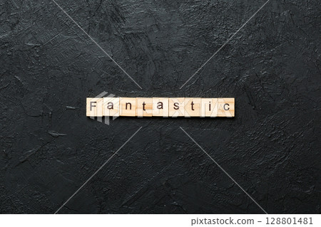 fantastic word written on wood block. fantastic text on cement table for your desing, concept 128801481