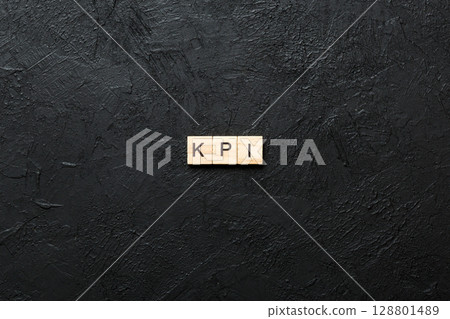 kpi word written on wood block. key performance indicators text on table, concept kpi word written on wood block. key performance indicators text on table, concept 128801489