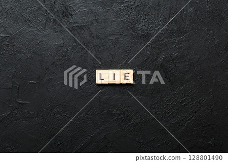 LIE word written on wood block. LIE text on cement table for your desing, concept 128801490