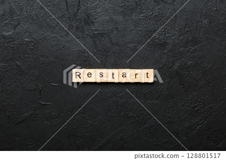 restart word written on wood block. restart text on table, concept 128801517