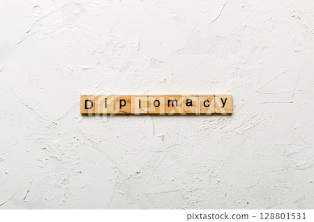 diplomacy word written on wood block. diplomacy text on cement table for your desing, concept diplomacy word written on wood block. diplomacy text on cement table for your desing, concept 128801531