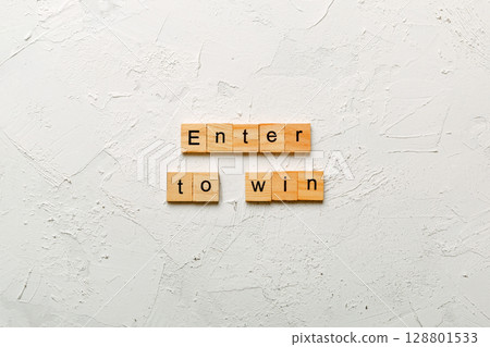 Enter To Win word written on wood block. Enter To Win text on cement table for your desing, concept Enter To Win word written on wood block. Enter To Win text on cement table for your desing, concept 128801533