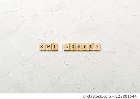 kpi word written on wood block. key performance indicators text on table, concept 128801544