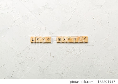 Love myself word written on wood block. Love myself text on cement table for your desing, Top view concept Love myself word written on wood block. Love myself text on cement table for your desing, Top view concept 128801547