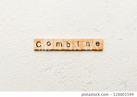 COMBINE word written on wood block. COMBINE text on cement table for your desing, concept COMBINE word written on wood block. COMBINE text on cement table for your desing, concept 128801594