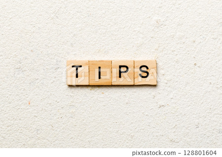 tips word written on wood block. tips text on table, concept 128801604