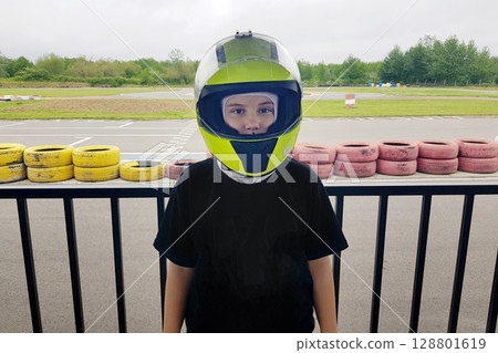 Cute child in helmet ready to go-karts 128801619