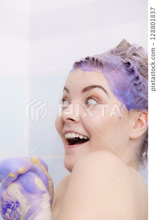 Woman applying toner shampoo on her hair 128801837