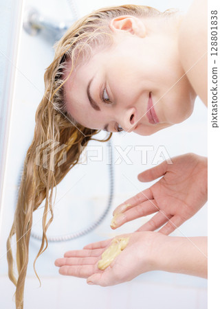 Woman having wet blonde hair 128801838