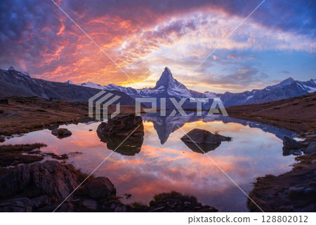 Dramatic light paints Stellisee and Matterhorn in vibrant colors 128802012