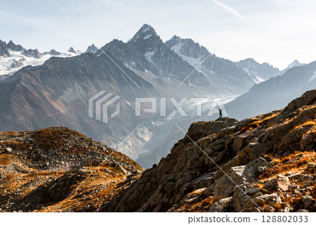 Monte Bianco mountains rise beyond hiker in foreground 128802033