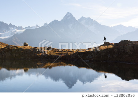 Tourist admires Monte Bianco range from Lac de Cheserys 128802056