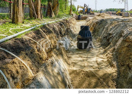 Trench dewatering System Installation with plastic and metal Pipes on Construction Site 128802212