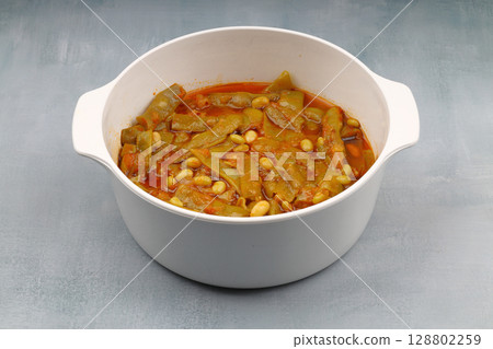Homemade stewed green beans, tomatoes, garlic with olive oil. Zeytinyagli fasulye traditional food. Turkish cuisine. Homemade stewed green beans, tomatoes, garlic with olive oil. Zeytinyagli fasulye traditional food. Turkish cuisine. 128802259