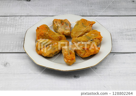 Pumpkin or Zucchini Flowers Dolma Stuffed with Rice Pilaf . Turkish Food in Plate. Traditional Organic Food. Pumpkin or Zucchini Flowers Dolma Stuffed with Rice Pilaf . Turkish Food in Plate. Traditional Organic Food. 128802264