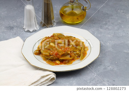 Homemade stewed green beans, tomatoes, garlic with olive oil. Zeytinyagli fasulye traditional food. Turkish cuisine. Homemade stewed green beans, tomatoes, garlic with olive oil. Zeytinyagli fasulye traditional food. Turkish cuisine. 128802273