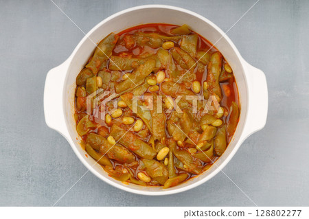 Homemade stewed green beans, tomatoes, garlic with olive oil. Zeytinyagli fasulye traditional food. Turkish cuisine. Homemade stewed green beans, tomatoes, garlic with olive oil. Zeytinyagli fasulye traditional food. Turkish cuisine. 128802277
