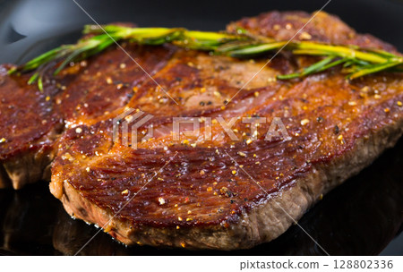 Grilled beef steak with rosemary 128802336