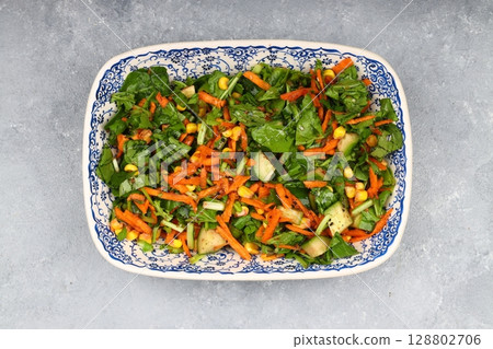 Mixed fresh Turkish salad. Carrots, arugula, cucumber, basil, pepper, black cumin, pepper, corn and plenty of olive oil in a serving plate. Healthy summer food. Mixed fresh Turkish salad. Carrots, arugula, cucumber, basil, pepper, black cumin, pepper, corn and plenty of olive oil in a serving plate. Healthy summer food. 128802706