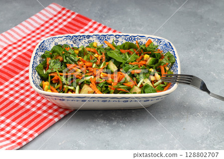 Mixed fresh Turkish salad. Carrots, arugula, cucumber, basil, pepper, black cumin, pepper, corn and plenty of olive oil in a serving plate. Healthy summer food. Mixed fresh Turkish salad. Carrots, arugula, cucumber, basil, pepper, black cumin, pepper, corn and plenty of olive oil in a serving plate. Healthy summer food. 128802707