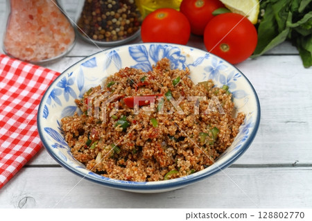 Traditional Turkish bulgur salad Kisir close-up on a plate on the table. Horizontal view from above Traditional Turkish bulgur salad Kisir close-up on a plate on the table. Horizontal view from above 128802770