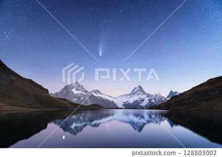 Alpine lake Bachalpsee under night starry sky with snow-covered peaks Alpine lake Bachalpsee under night starry sky with snow-covered peaks 128803002