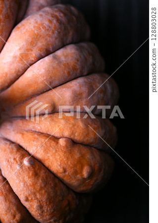 Close-up shot of Black Futsu squash showing colorful textured skin 128803028