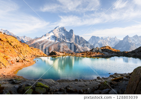 Crystal-clear Lac Blanc reflects sky and Mont Blanc range in French Alps 128803039